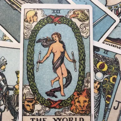Collage van kaarten, met de tarotkaart "De wereld" bovenaan